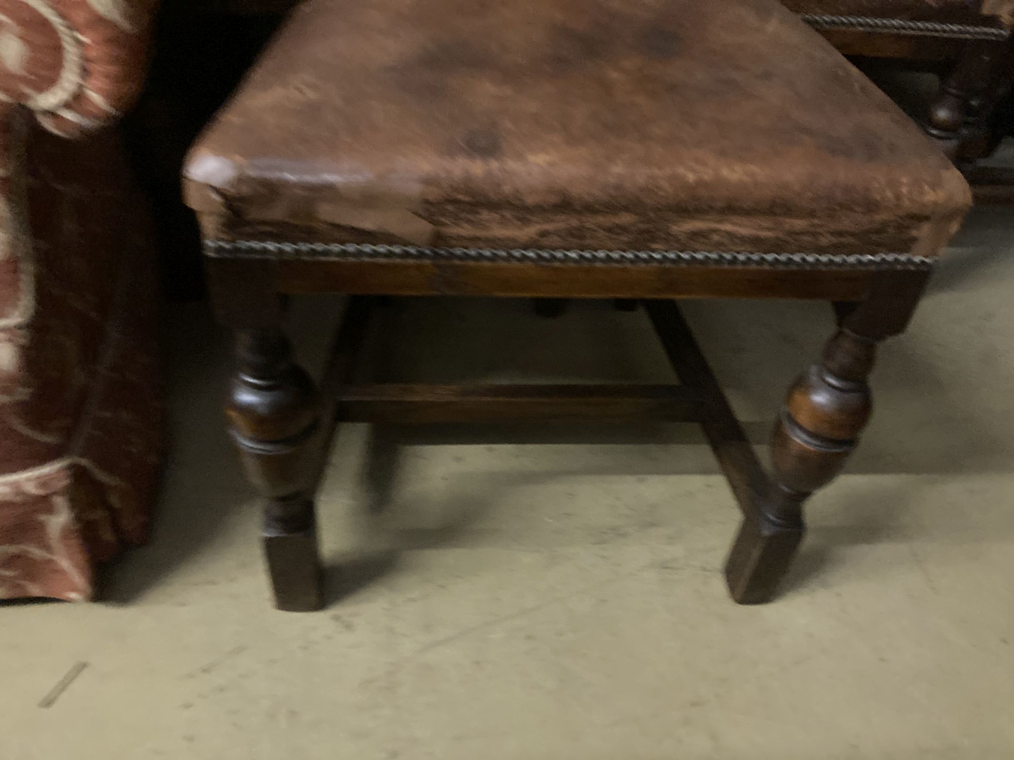 A set of four 1920s oak and tan leather dining chairs, height 109cm